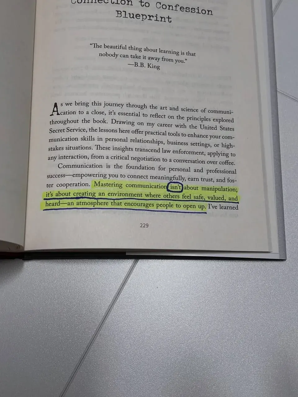 Portrait photo of a printed book page about communication principles and learning