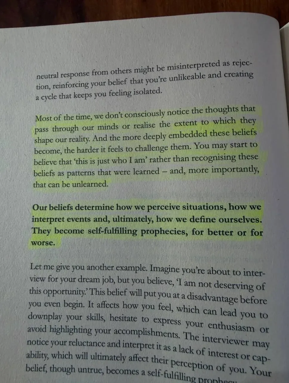 Portrait photo of a printed page about how beliefs shape our reality and can become self-fulfilling patterns