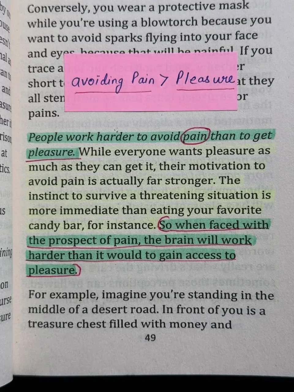 Close-up of a book page discussing how people work harder to avoid pain than to gain pleasure